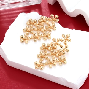 Close-up of golden multi-layer floral drop earrings on a stone display with red backdrop