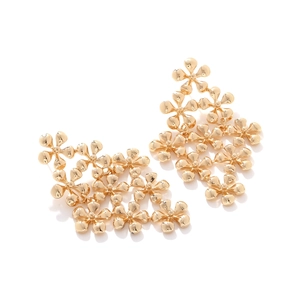 Macro shot of tiered golden floral cascading earrings with intricate petal textures