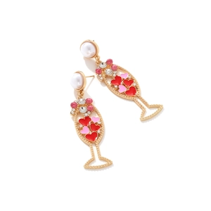 Elegant champagne glass drop earrings with heart crystals and pearls on white background
