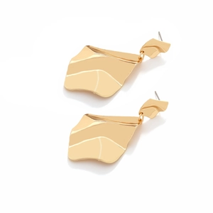 Detailed view of long gold alloy earrings with irregular wavy texture and polished finish