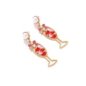 Detailed shot of champagne glass earrings with pink heart enamel and pearl studs
