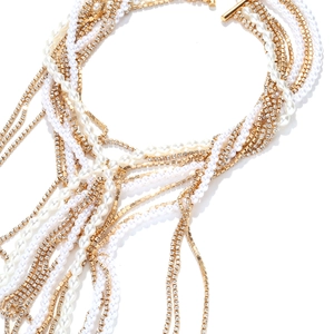Détail macro d'un collier multicouche avec perles, chaînes en strass et fermoir doré chic
