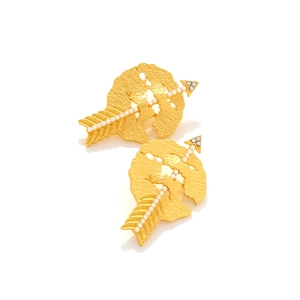 Detail of gold cupid arrow earrings featuring textured heart charms and pearl inlay