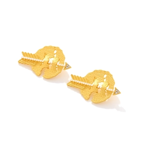 Detail of gold-plated arrow earrings with hammered metal, white pearls, and zircon