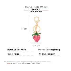 Detail view of pink strawberry keychain showing dimensions 11x3.4cm and lobster clasp