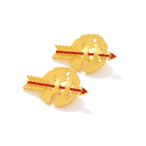 Detail of gold cupid arrow earrings with red rhinestones and hammered texture