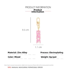 Detail of pink BRIDE enamel keychain showing 9.5cm height dimension on white background