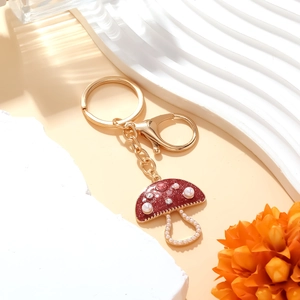 Charming red glitter mushroom keychain with white pearls and sparkling crystals