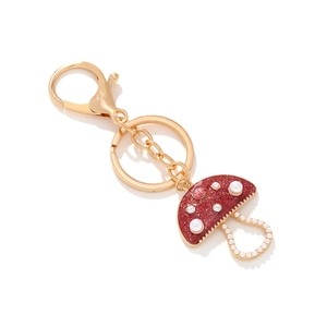 Enamel mushroom keychain with red glitter and faux pearls on a gold-tone lobster clasp