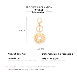Detailed view of golden sun keychain with dimensions 11.8 cm height and 5.5 cm width