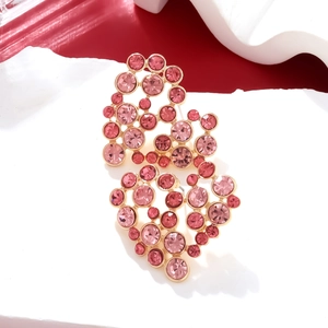 Detail of pink crystal clusters on golden metal base for elegant heart stud earrings