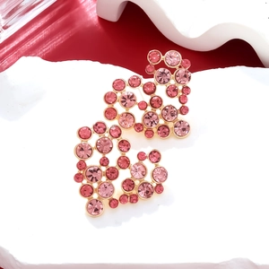 Chic gold-plated heart stud earrings with sparkling pink rhinestones on stone pedestal