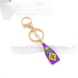Porte-clés bouteille de carnaval avec émail coloré et fleur de lys sur socle en pierre