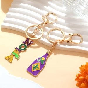 Détail des breloques NOLA de Mardi Gras et bouteille en émail avec finition dorée