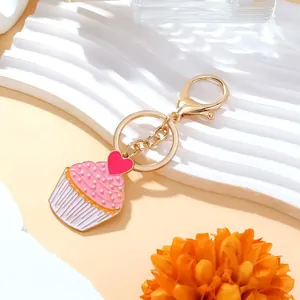 Sweet pink enamel cupcake keychain with pearl accents and golden lobster clasp
