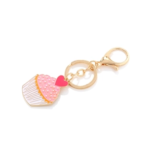 Enamel cupcake keychain with pink cream detail, pearl accent, and a red heart charm