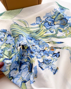 Close-up of blue iris floral print scarf with elegant silk texture and fine twill weaving