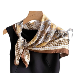Elegant houndstooth silk square scarf with floral patterns displayed on a hanger