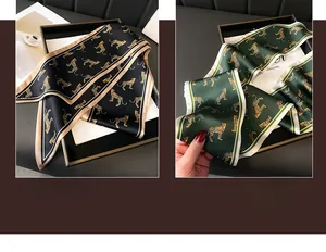 Detail of leopard print silk neck scarf with contrast borders in black and gold