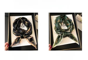 Leopard print skinny scarves in black and green colors shown inside a premium gift box