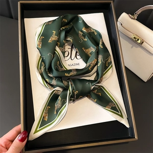 Dark green leopard print silk scarf for women in elegant luxury gift box display