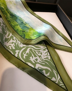 Close-up of artistic impressionist oil painting pattern on a green satin silk twilly scarf