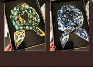 Close-up of dual-color paisley print scarves in green and blue with silk-like texture