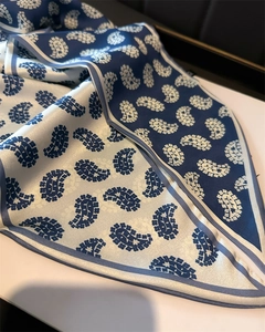 Detailed view of paisley print on navy and cream satin scarf with soft drapes