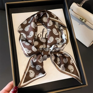 Brown paisley silk scarf in a black gift box with a white bag background