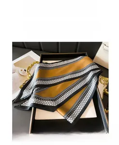 Close-up of elegant double-layer silk scarf with geometric chain pattern in luxury gift box