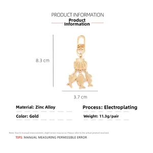 Detailed view of gold ocean shell and fish keychain with dimensions 8.3cm x 3.7cm