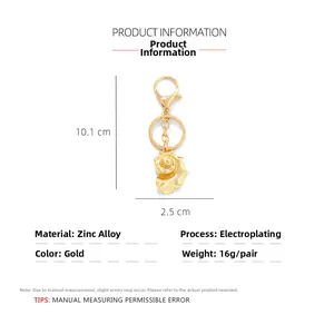 Detail of shell keychain pendant with dimensions 10.1cm by 2.5cm in golden zinc alloy