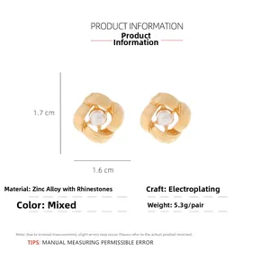 Detail of square gold-tone geometric earrings with pearl and rhinestone inlay