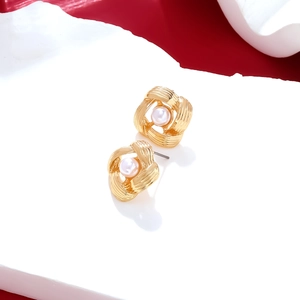 Minimalist gold alloy hollow hoop earrings with imitation pearls in a twisted design