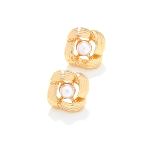 Elegant gold knot earrings with white pearls featuring a brushed metal texture