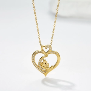Gouden hartketting met zirkonia rand en moeder-kind figuur in de hanger