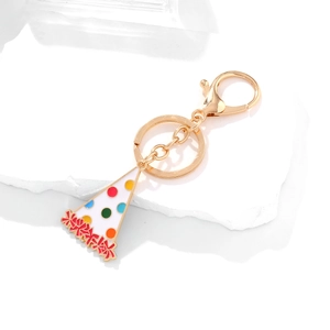 Golden keychain with enamel birthday hat pendant featuring colorful dots and red bows