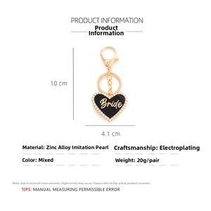 Detail view of 10cm Bride heart keychain with black enamel and faux pearl inlay