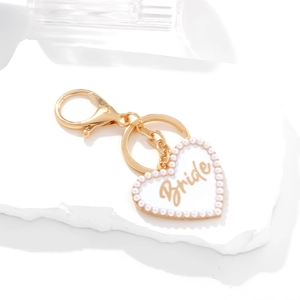 Golden heart-shaped Bride keychain with white enamel and pearl border detail