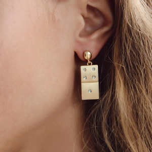 Vintage golden domino drop earrings with rhinestone accents on a female model