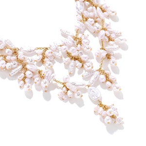 Macro detail of layered Baroque pearl necklace with irregular pearls and golden chain