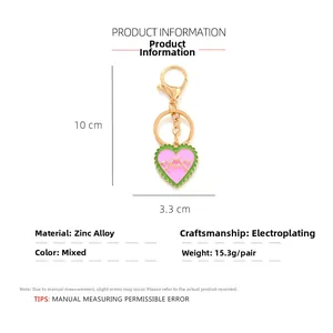 Detailed view of enamel heart keychain with gold thorns, dimensions 10cm x 3.3cm