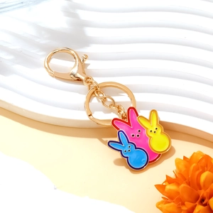 Colorful Easter rabbit keychain with three enamel bunny pendants in gold-tone metal finish