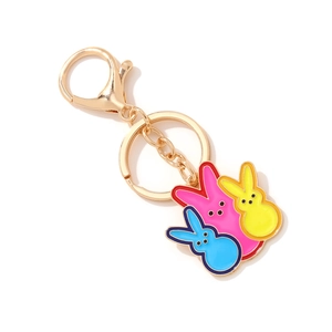 Golden keychain with three colorful enamel Easter bunnies in yellow, pink and blue