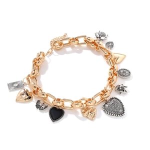 Detail of vintage gold charm necklace featuring heart, butterfly and flower pendants