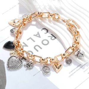 Elegant gold chunky chain bracelet with vintage heart, bee, and flower charms