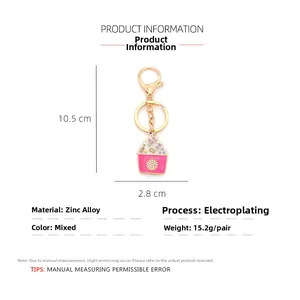Detail view of pink cupcake keychain with zinc alloy dimensions and weight specs