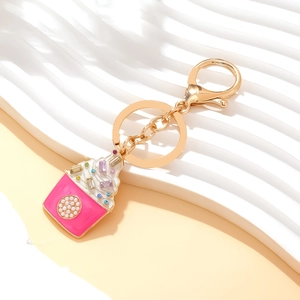 Pink cupcake keychain with enamel frosting and colorful rhinestones on gold chain