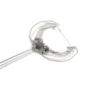 Elegant multi-layered silver necklace featuring three 3D daisy pendants and textured chains
