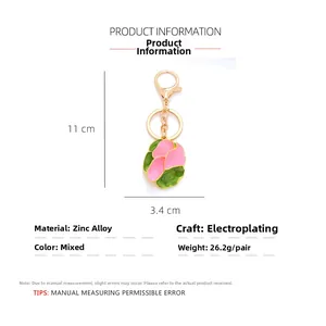 Pink enamel flower keychain in gold plated zinc alloy with size and weight specs